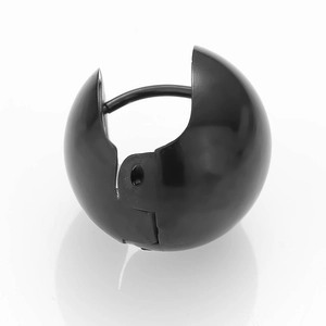 Minimalist black spherical huggie earring with a smooth polished finish on white background