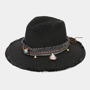 Detail of black straw fedora with turquoise beadwork, ethnic weaving, and pink tassels