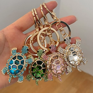 Colorful turtle crystal keychains in blue, green, pink and white with gold metal rings