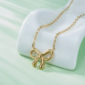Minimalist golden bowknot pendant necklace for women in polished titanium steel
