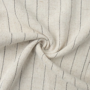 Detailed macro view of beige striped linen fabric showing soft texture and vertical patterns