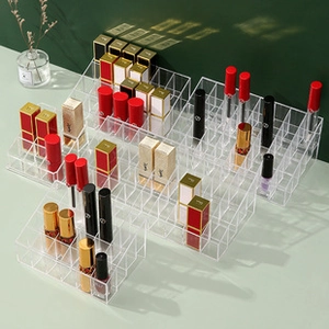 Macro shot of clear acrylic lipstick organizer with tiered slots and light shadows