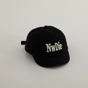 Detail of white NwDie 3D embroidery on a black cotton twill baseball cap for kids