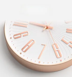Detail of rose gold modern wall clock showing 3D embossed numerals and textured dial