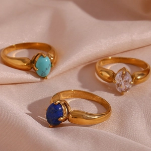 Detailed view of three 18K gold plated rings with turquoise, lapis and zircon stones