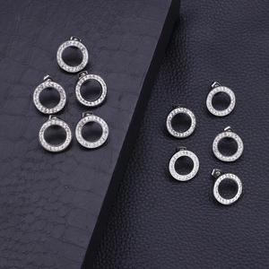 Polished silver stainless steel hoop earrings with white zircon crystals on black box
