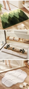 Absorbent bath mats featuring green mountains, cactus prints and cloud shapes