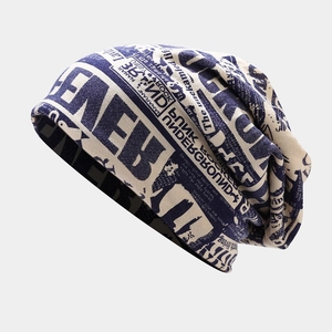 Detail of slouchy beanie with vintage newspaper print and navy blue contrast knit