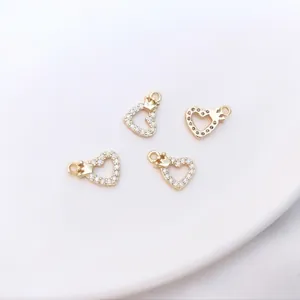 Macro shot of four 14K gold plated heart crown charms with micro paved cubic zirconia
