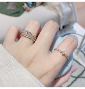 Detailed view of silver crown ring and rose gold solitaire stackable jewelry set