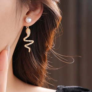 Elegant 14K gold plated serpent drop earrings with pearls and zircon on model