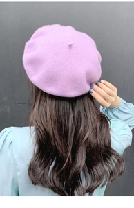 Rear view of model wearing a light purple wool beret showing its elegant silhouette and texture