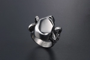 Detailed close-up of a punk style ram horn ring made of polished steel with mechanical textures