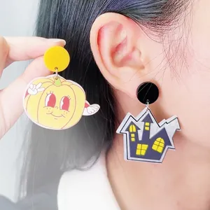 Acrylic Halloween earrings featuring a vintage pumpkin and purple haunted house design