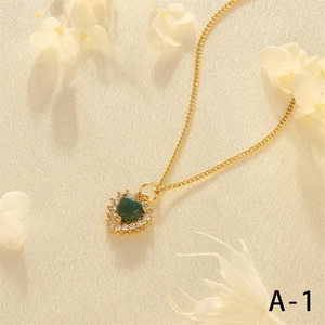 Close-up of green heart gemstone pendant with zircon pavé on 18K gold plated chain