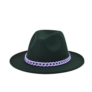 Close-up of a forest green wool fedora hat featuring a chunky purple acrylic chain decoration