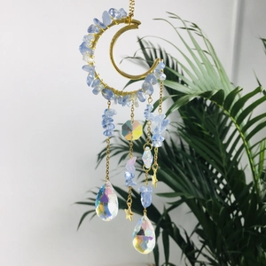 Detailed view of moon suncatcher with amethyst stones and hanging crystal prisms