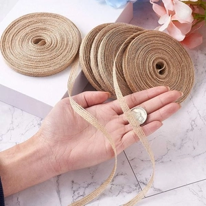 Close-up of natural jute ribbon rolls with detailed texture and size reference coin
