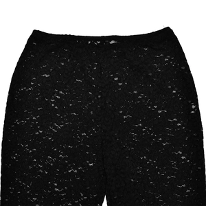 Close-up of elastic waistband on black floral lace trousers with sheer hollow-out texture