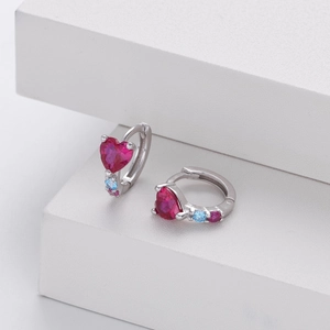 Macro shot of S925 silver heart-shaped ruby hoop earrings with colorful zircon accents
