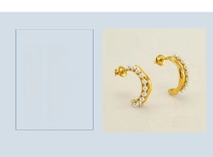 Detailed view of 18K gold plated titanium C-shaped earrings with inlaid white pearls