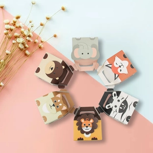Top view of six assorted cartoon animal paper candy boxes in a circular arrangement