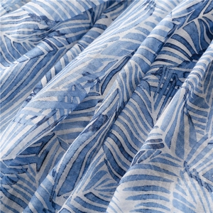 Detail of blue banana leaf pattern and fringe on lightweight breathable linen scarf
