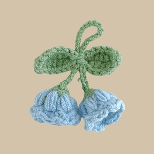Handmade crochet lily of the valley keychain with blue flowers and green leaves