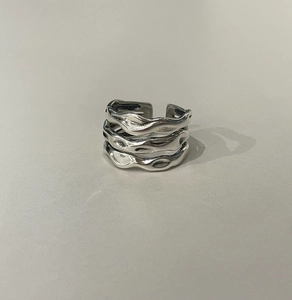 Detailed close-up of textured wavy multi-layer 925 silver open ring with vintage finish