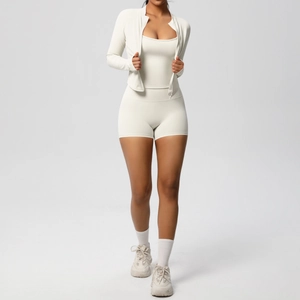 Three-piece beige yoga set with long sleeve zip jacket, sports bra and high waist shorts