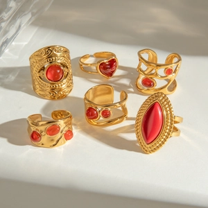 Set of six vintage gold rings with red stones in heart, oval and woven patterns