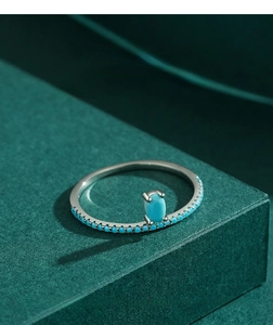 Macro detail of S925 sterling silver ring with inlaid turquoise stones on dark stand