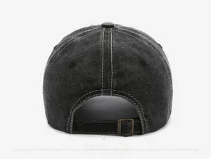 Detail view of washed denim baseball cap back featuring contrast stitching and metal buckle