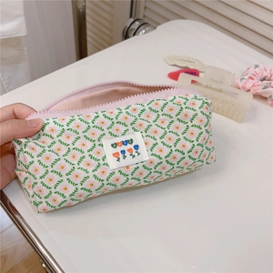 Detailed close-up of a pink floral cotton pouch with a zipper and best tag