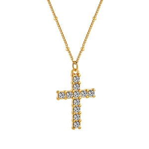 Detail of golden stainless steel cross pendant featuring sparkling cubic zirconia stones
