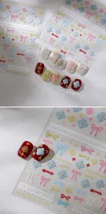 Detail of embossed bow and floral nail art stickers with gold stamping finish