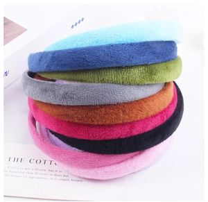 Pile of colorful plush fabric headbands in various solid colors for DIY hair accessories