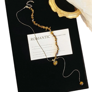 Vintage stainless steel necklace with tiger eye stone pendant on elegant flat lay