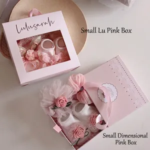 Pink baby socks gift set with floral bow details in an elegant window display box