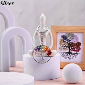 Detailed view of silver tree of life keychain with colorful seven chakra tumbled stones