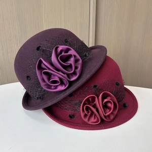 Detail of wool felt hats featuring satin floral decor and polka dot mesh veils