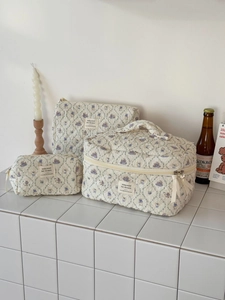 Three-piece quilted cotton floral rabbit cosmetic bags on a clean white countertop