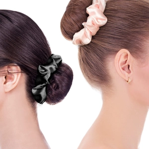 Silk scrunchies in black and pink colors shown on hair buns for a stylish look