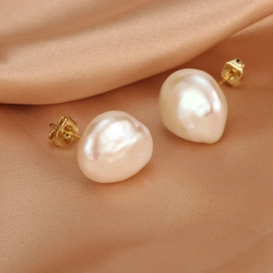 Macro shot of baroque freshwater pearl earrings with 18K gold plated zircon settings