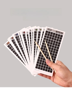 Detail of 18 Truth or Dare scratch cards with two wooden styluses for interactive fun