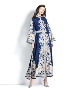 Detailed view of the baroque pattern on this vintage navy maxi dress with long flare sleeves