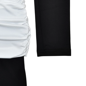 Close-up of the black and white patchwork dress featuring detailed pleated fabric and stitching