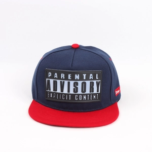 Detail of navy blue snapback cap with red brim and explicit content rubber patch