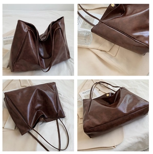 Detail view of the deep brown leather tote bag showing fine stitching and magnetic closure