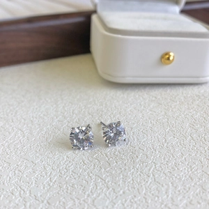 Macro shot of 925 silver stud earrings with classic four-prong set round zircon